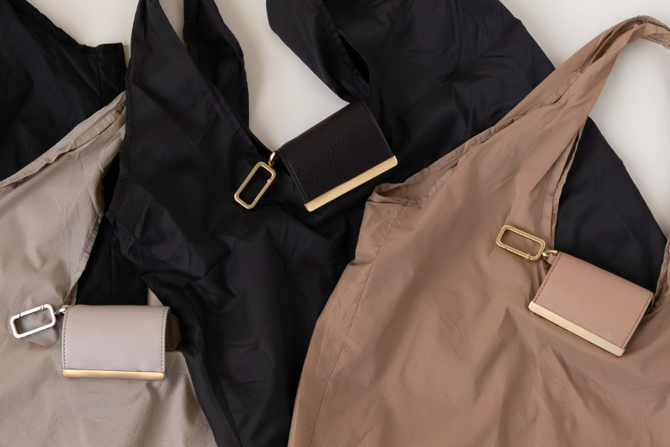 Brown and black bags with gold hardware on a white background